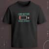 Black regular-fit T-shirt with “Low Battery High Spirit” teal text, battery icon, red low-charge detail, and lightning graphic.